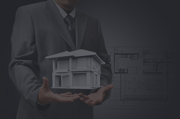 The house in hands on blue print