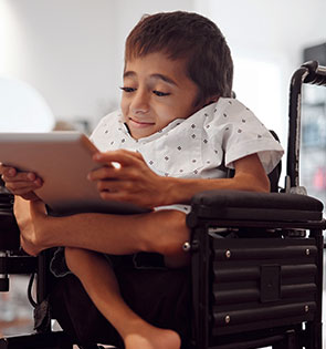 Boy in wheelchair with tablet