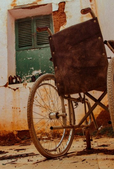 Carer with senior man in wheelchair